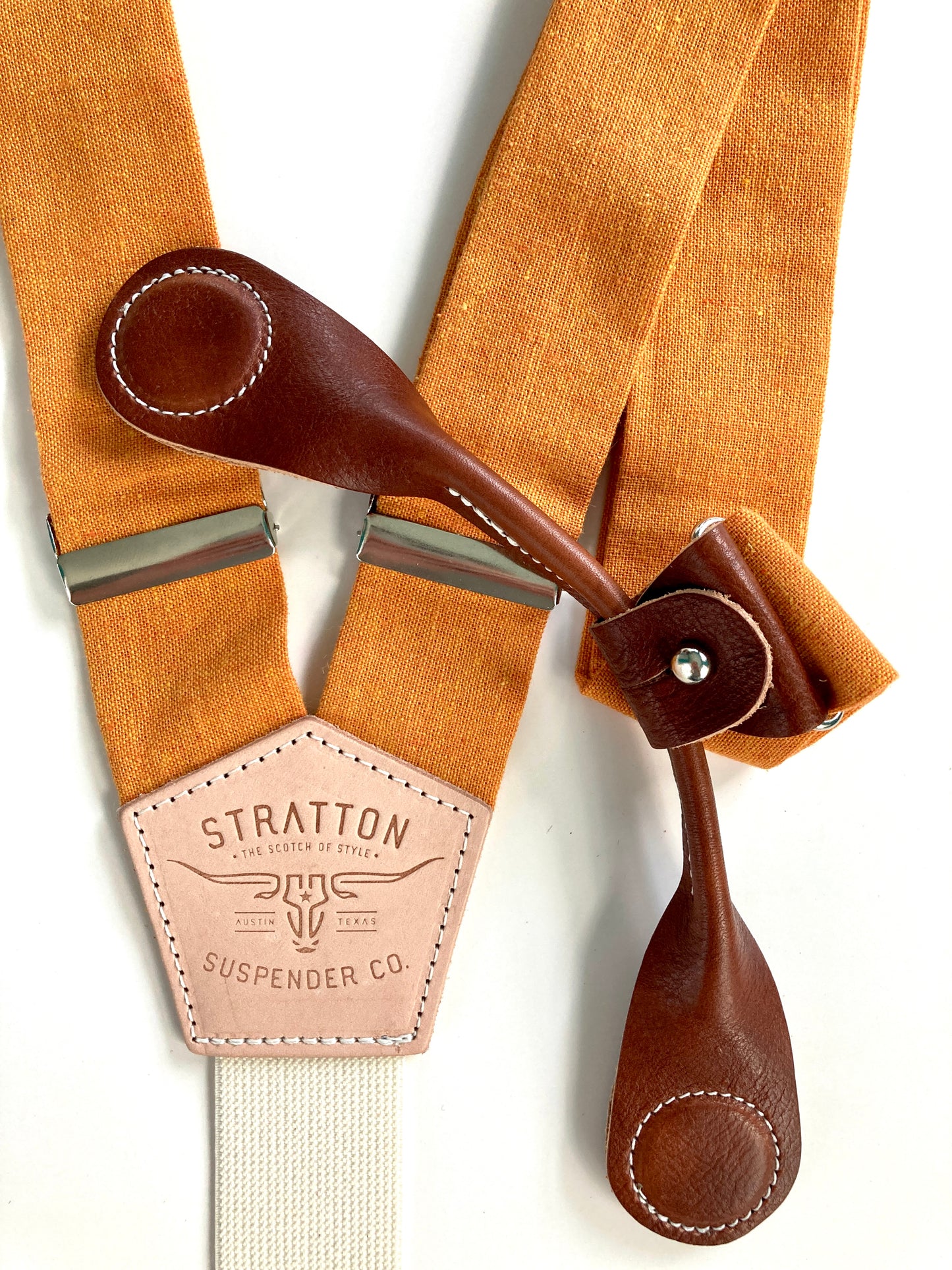 Stratton Suspender Co. features the orange linen suspenders on veg tan shoulder leather with cream colored elastic back strap for the Fall 2022 suspenders collection Magnetic Stratton Suspender clasps in Cognac Pontedero Italian leather hand-picked by Stratton Suspender Co.