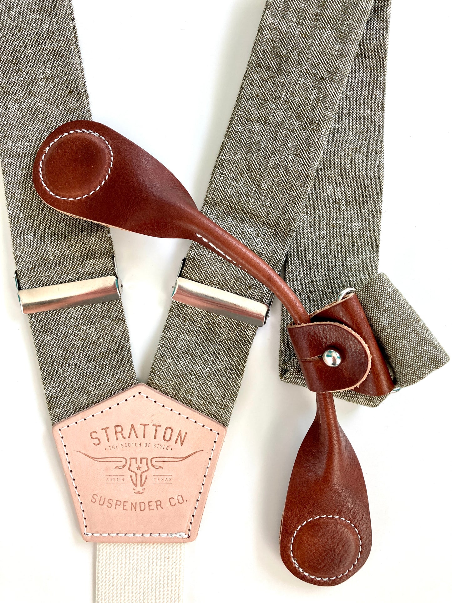 Stratton Suspender Co. features the Olive Green linen suspenders on veg tan shoulder leather with cream colored elastic back strap for the Fall 2022 suspenders collection Magnetic Stratton Suspender clasps in Cognac Pontedero Italian leather hand-picked by Stratton Suspender Co.