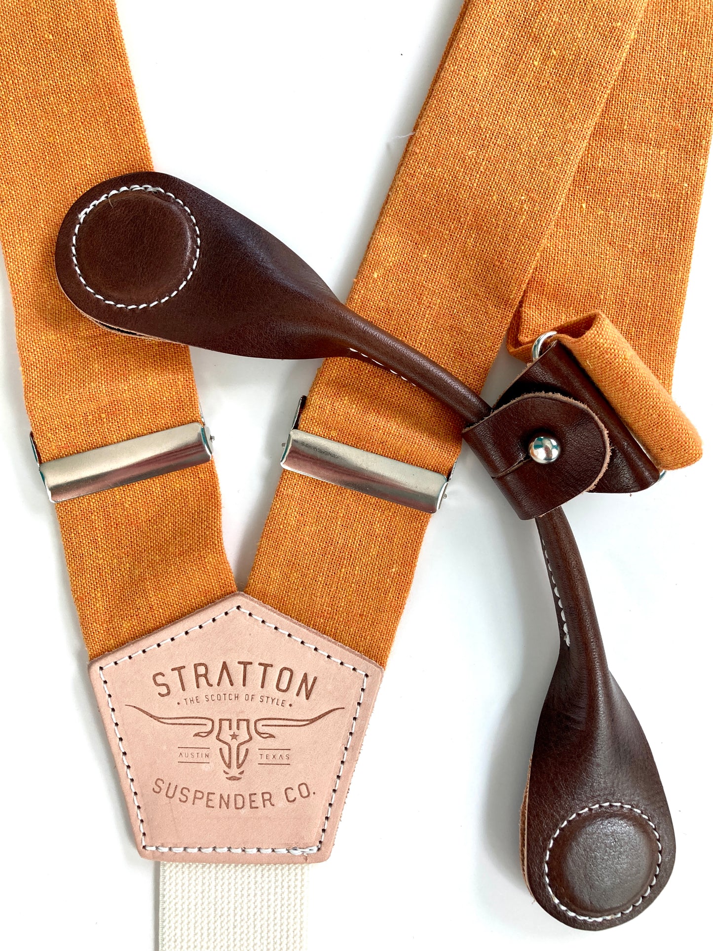 Stratton Suspender Co. features the orange linen suspenders on veg tan shoulder leather with cream colored elastic back strap for the Fall 2022 suspenders collection Magnetic Stratton Suspender clasps in Chocolate Pontedero Italian leather hand-picked by Stratton Suspender Co.