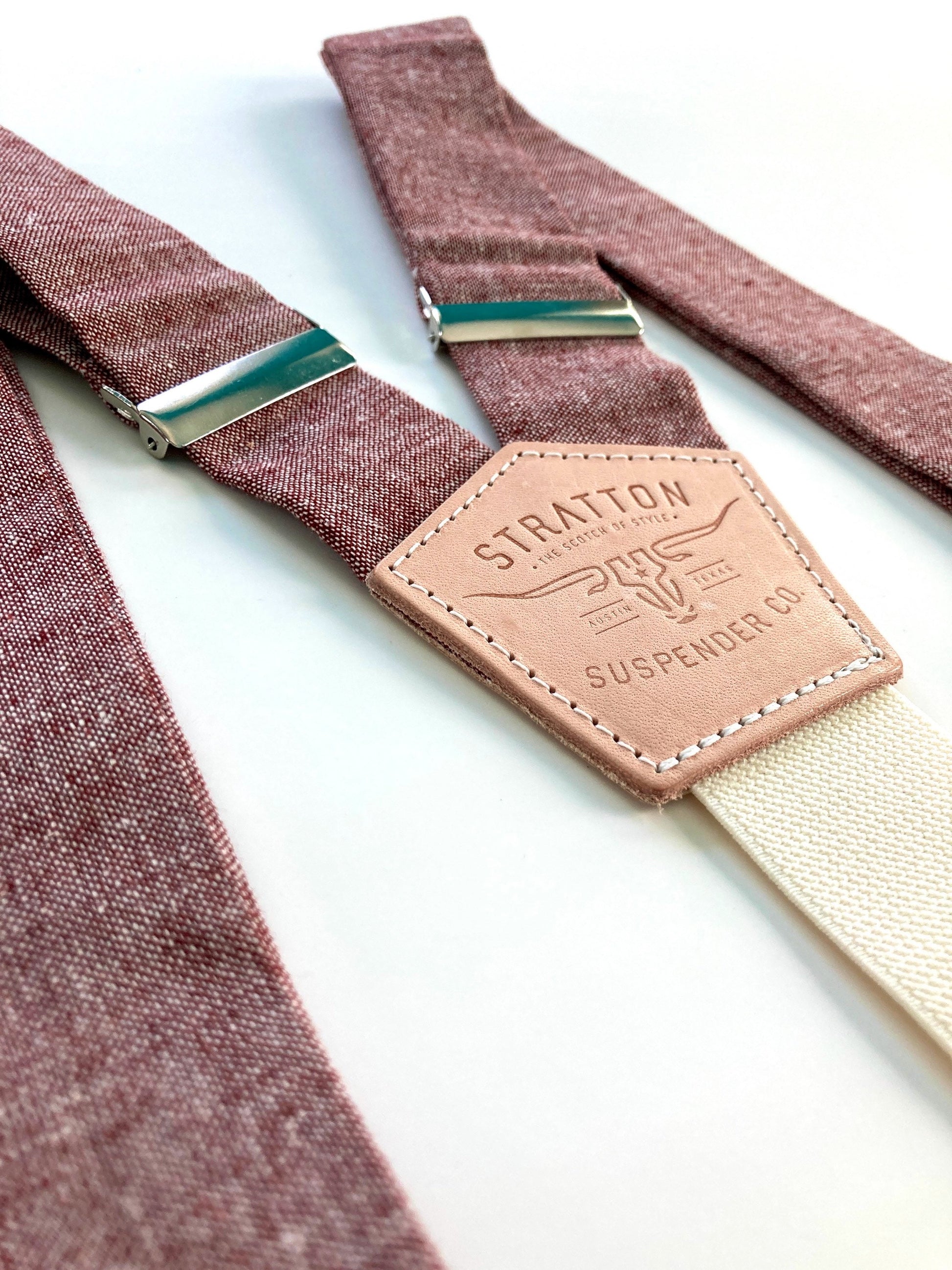Stratton Suspender Co. features the Rust (Maroon) linen suspenders on veg tan shoulder leather with cream colored elastic back strap for the Fall 2022 suspenders collection 