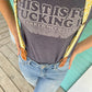 Women’s suspenders with tan leather magnetic clasps, paired with light-wash jeans for casual spring style.